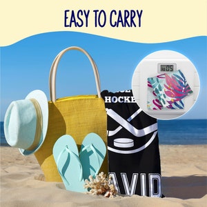 May include: A beach scene featuring a yellow tote bag, a light blue hat, and flip-flops. A black beach towel with a hockey design and the name "DAVID" is next to the bag. The text "EASY TO CARRY" is at the top. A scale shows the weight of the towel, approximately 0.5 kg.
