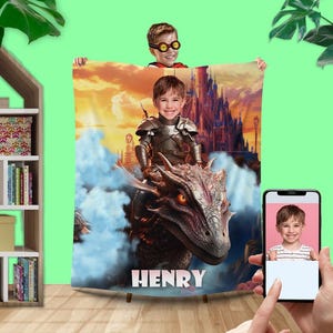 May include: A personalized fleece blanket with a fantasy theme. A young boy is riding a dragon in front of a castle. The blanket has the name "HENRY" printed on it.