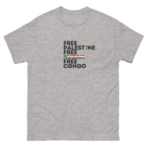May include: A heather grey t-shirt with the text "FREE PALESTINE FREE SUDAN FREE CONGO" printed on the front. The text is in black and is stacked vertically. The text is accompanied by the flags of Palestine, Sudan, and Congo.