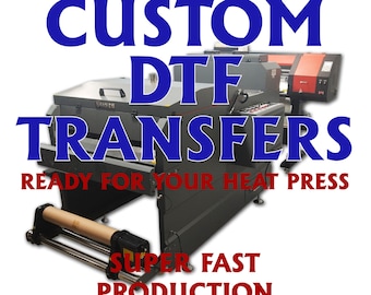 May include: A large industrial machine with a roll of paper, used for printing custom DTF transfers. The machine is labeled "CUSTOM DTF TRANSFERS READY FOR YOUR HEAT PRESS" in blue text and "SUPER FAST PRODUCTION SHIPPING" in red text.