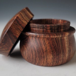 Hand turned round threaded lidded keepsake box made from Chechen wood.