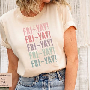 May include: A cream colored t-shirt with the text "FRI-YAY!" repeated five times in a gradient of pink, purple, blue, and green.