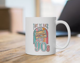 May include: White ceramic mug with a colorful graphic of a cassette tape and the text "Take Me Back to the 90s".