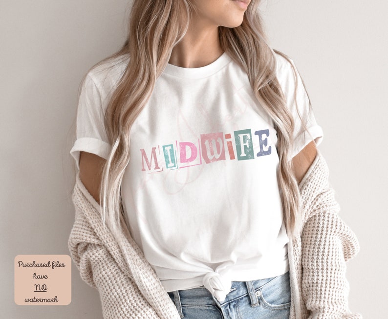 May include: A white t-shirt with the word "MIDWIFE" printed on it in colorful, block letters. The letters are slightly distressed and have a vintage look.