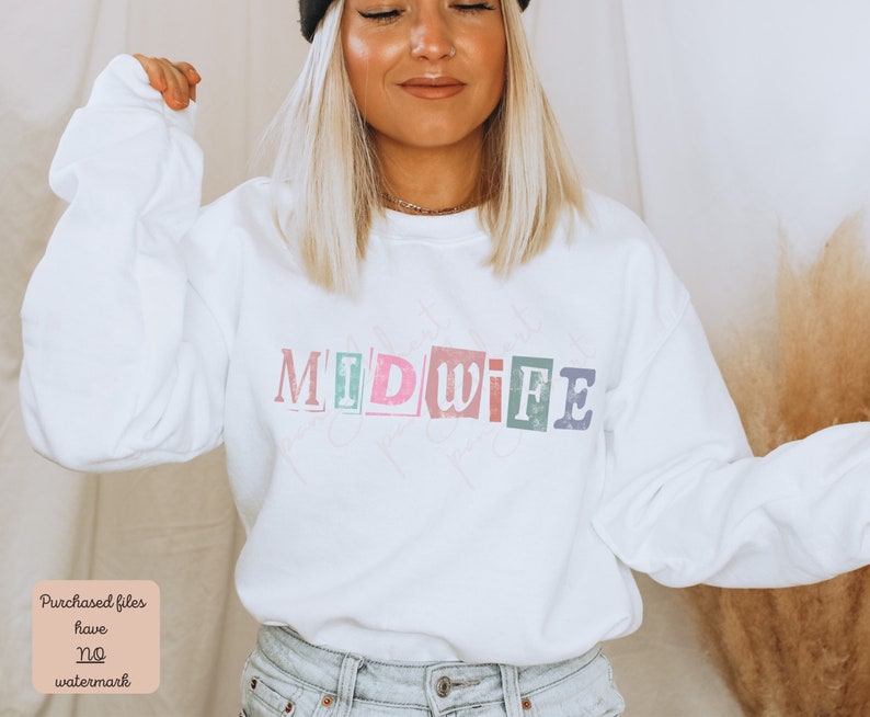 May include: White sweatshirt with the word "MIDWIFE" printed in colorful, distressed letters. The letters are arranged in a staggered pattern.