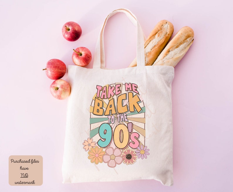 May include: A white canvas tote bag with the text "Take Me Back to the 90's" in colorful retro font. The text is surrounded by a colorful sunburst design and flowers.