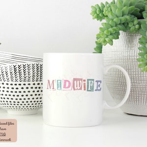 May include: White ceramic mug with the word "MIDWIFE" printed in colorful, block letters. The mug is sitting on a white surface next to a potted succulent plant.