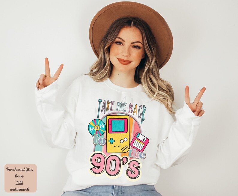 K&ouml;nnte beinhalten: Wei&szlig;er Pullover mit einem Grafikdruck eines Retro-Videospiels, einer Diskette und einer Schallplatte. Der Text auf der Grafik lautet "Take Me Back to the 90's".