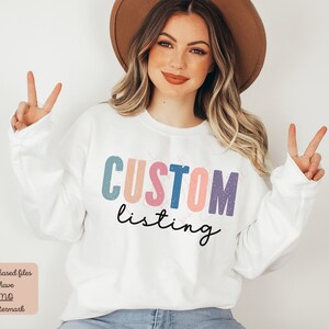 May include: White sweatshirt with the text "CUSTOM listing" in colorful, distressed letters. The letters are in shades of pink, blue, and purple.
