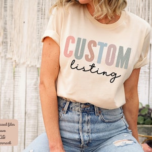 May include: A beige t-shirt with the text "CUSTOM listing" in colorful block letters. The letters are in shades of pink, blue, and green with a speckled texture.