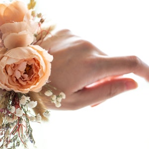 Matching terracotta dried flower wrist corsage is avaliable for mother and groom of the bride.