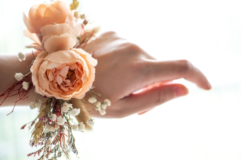 Matching terracotta dried flower wrist corsage is avaliable for mother and groom of the bride.