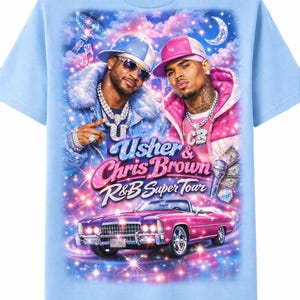 May include: Light blue t-shirt featuring a graphic of Usher and Chris Brown. The design includes the text "Usher & Chris Brown R&B Super Tour" above a pink car. The background has a starry night sky with a crescent moon.