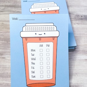 May include: A blue pill reminder card with a cartoon pill bottle with a smiling face. The card has a space to write the week number and a checklist for each day of the week with AM and PM columns.