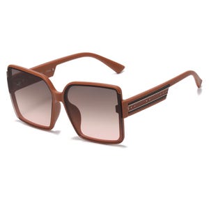 May include: Brown square sunglasses with gradient lenses. The frames are a solid brown color, with a decorative stripe detail on the temples. The lenses transition from a darker shade at the top to a lighter shade at the bottom.