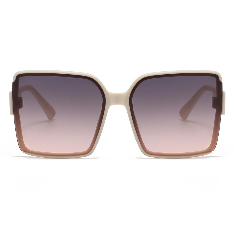 May include: Oversized square sunglasses with a cream-colored frame and gradient lenses that transition from dark gray to pink. The sunglasses have a thick frame and a classic, yet modern design.
