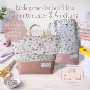 Może przedstawiać: Zestaw dwóch toreb materiałowych, jedna z uchwytami, a druga ze sznurkiem, z kwiatowym i owadzim wzorem z tęczami. Torby mają jasnoróżową podstawę i są oznaczone jako "Kindergarten-Set Leni & Lino" i "PDF Download".