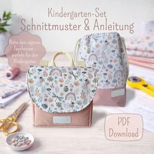 Könnte beinhalten: Ein rosa-weißes Kindergarten-Set mit Blumen- und Insektenmuster, einschließlich Rucksack und Kordelzugbeutel. Das Set zeigt ein Regenbogen-Design und den Text "Kindergarten-Set Schnittmuster & Anleitung" und "PDF Download".