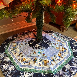 Snowflakes, Snowmen and furry friends winter tree skirt.  Measures 31 inches across.
