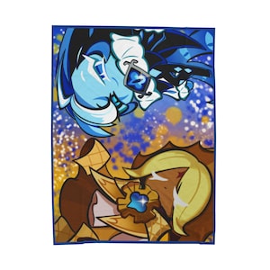 Puede incluir: Una manta rectangular con una colorida ilustración de dos personajes de dibujos animados. Uno es azul claro con detalles en azul oscuro, y el otro es marrón con detalles dorados. El fondo tiene salpicaduras azules, amarillas y blancas.