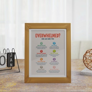 May include: A gold framed motivational poster with the text "Overwhelmed? Here are some tips:" and a list of tips for managing stress and overwhelm. The tips include taking smaller steps, seeking help, grounding techniques, setting boundaries, and practicing acceptance.