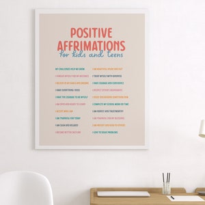 May include: A framed print with the words "POSITIVE AFFIRMATIONS for kids and teens" in colorful text. The print lists positive affirmations such as "I am beautiful inside and out" and "I have courage and confidence."