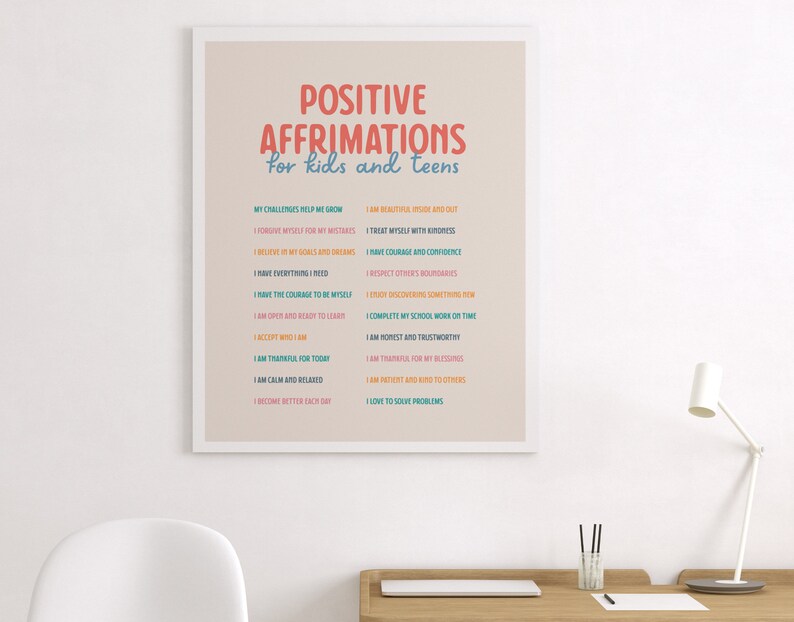 May include: A framed print with the words "POSITIVE AFFIRMATIONS for kids and teens" in colorful text. The print lists positive affirmations such as "I am beautiful inside and out" and "I have courage and confidence."