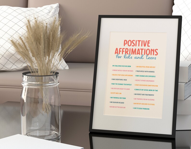 May include: A framed print with the words "POSITIVE AFFIRMATIONS for kids and teens" in red and blue. The print lists affirmations such as "I am beautiful inside and out" and "I have courage and confidence."