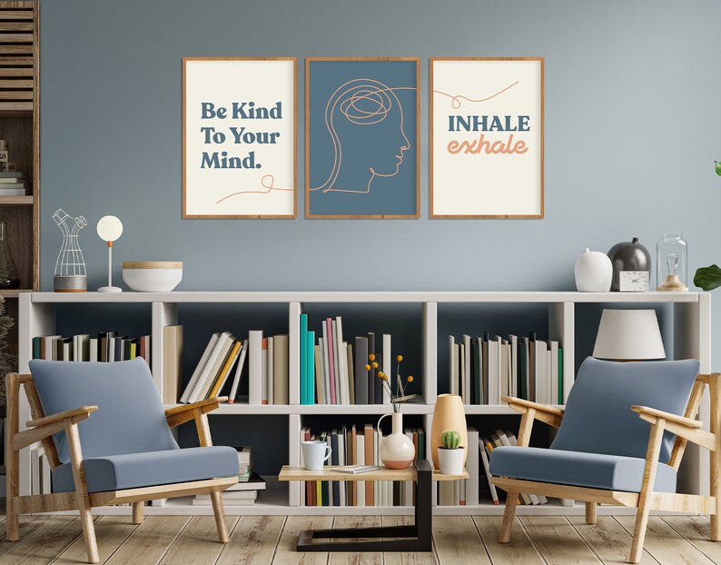 May include: Three framed wall art prints with inspirational quotes. The first print reads "Be Kind To Your Mind." The second print features a line drawing of a head. The third print says "Inhale exhale." The frames are brown.