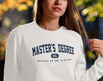 May include: White sweatshirt with the text "MASTER'S DEGREE" in navy blue, with the phrase "BECAUSE NO ONE IS HIRING" underneath. The sweatshirt is XXL size. The person is wearing blue jeans and white sneakers.