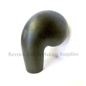 May include: A dark, curved handle for a walking stick, with a rounded top and a curved, ergonomic design. The handle is a solid, matte black colour. The text "Rerrick STICK Making Supplies" is printed in light grey.