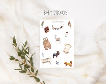 May include: A sheet of baby stickers with a watercolor style. The stickers feature a variety of baby-related images, including a crib, a bottle, a llama, a pair of shoes, a onesie, overalls, a donkey, and a squirrel. The text "Watercolor Baby" is printed on the sheet.