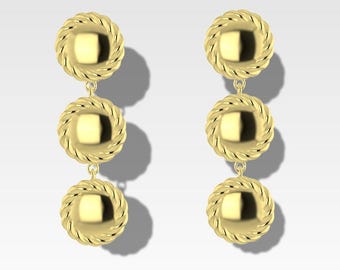 May include: A pair of gold earrings with three round, textured, dangling charms.