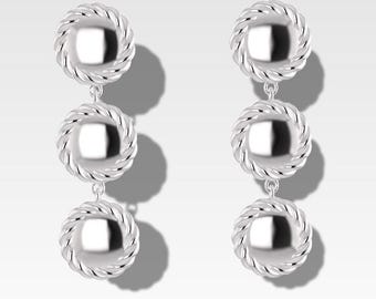 May include: Silver dangle earrings with three round, textured, silver discs.