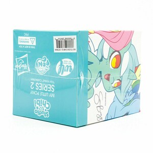 May include: A sealed box for the My Little Pony Chibi Series 2 "Fan Voted" Collection. The box is light blue with the Hasbro and My Little Pony logos. The box features a cartoon illustration of a pony with a pink mane and blue body.
