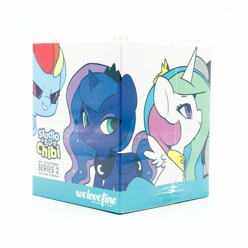 May include: A cube-shaped box featuring cartoon illustrations of My Little Pony characters. The box has a light blue base and the text "Studio Chibi" and "we love fine" are visible. The box is part of the "Fan Favorites Collection".