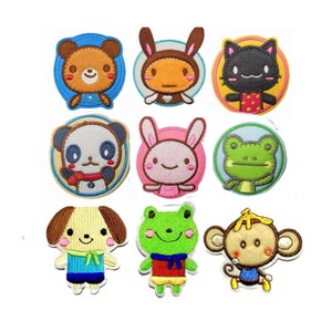 May include: A collection of nine embroidered fabric patches featuring various cartoon animal characters including a bear, rabbit, cat, panda, frog, dog, and monkey. Each patch displays vibrant colours, stitched outlines, and distinct facial features.
