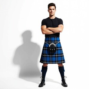 Man wearing a Ramsay Blue kilt with a Prince Charlie jacket, ideal for formal Scottish weddings and high-end heritage events.