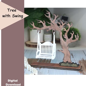 May include: A wooden tree with a swing, featuring a white swing hanging from the branches. The tree is brown with green accents at the base. The text "Tree with Swing" and "Digital Download" are visible.
