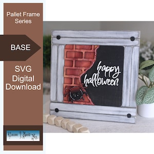 May include: A square wooden frame with a distressed white finish featuring a brick wall cutout, a black spider, and the white text "happy halloween" on a black background. The frame has four black circular accents at the corners.