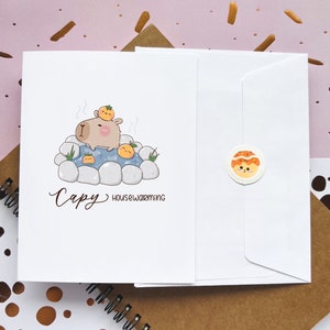 Carte heureuse mignonne de pendaison de crémaillère | chaleureux | Maison neuve | Célébration | Capybara | Kawaii amoureux des animaux | Cartes de voeux Punny