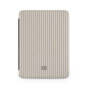 May include: A beige and white striped case with the initials "SR" in the lower center. The case has a black spine and a rounded top and bottom. The vertical stripes are evenly spaced.