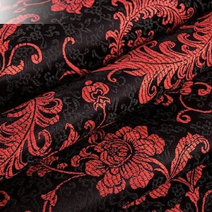 May include: Black fabric with a red floral pattern. The fabric has a textured, brocade-like appearance.