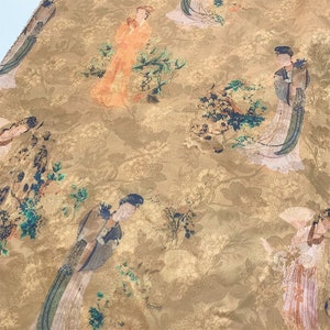 May include: A gold fabric with a repeating pattern of women in traditional clothing and floral designs. The fabric has a subtle texture and a warm, inviting feel.