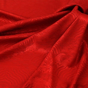 May include: Red fabric with a wave pattern embossed into the material.