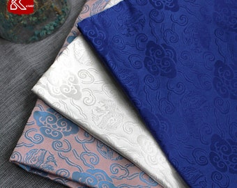 May include: Three pieces of fabric with a cloud pattern. The fabric is in blue, white, and pink.