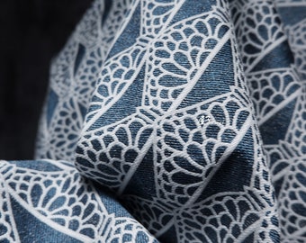 May include: Blue fabric with a white geometric pattern of overlapping circles and triangles.