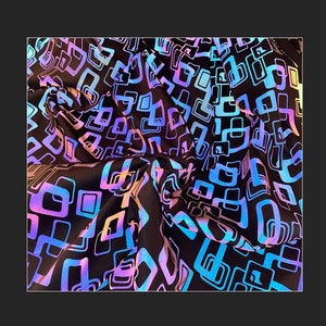 May include: Black fabric featuring a repeating pattern of iridescent, square-shaped designs. The squares have a gradient of colours, including blue, purple, and pink, creating a shimmering effect. The fabric is draped, showing folds and texture.