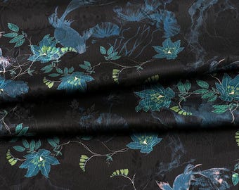 May include: Black fabric with a blue floral pattern. The fabric has a subtle sheen and a soft texture.