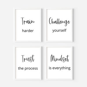 May include: Four white framed prints with black text on a white background. The prints read "Train harder", "Challenge yourself", "Trust the process", and "Mindset is everything".